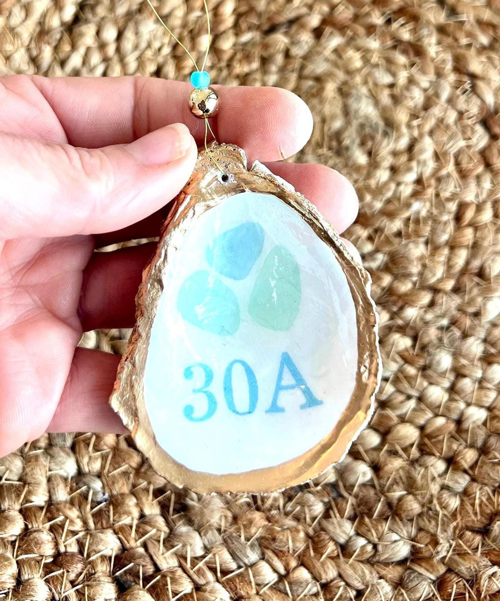 oyster shell ornament with pictures of small pastel and aqua sea glass and the words 30a
